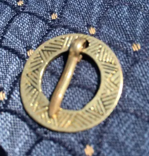 Round Medieval brooch with incised decoration