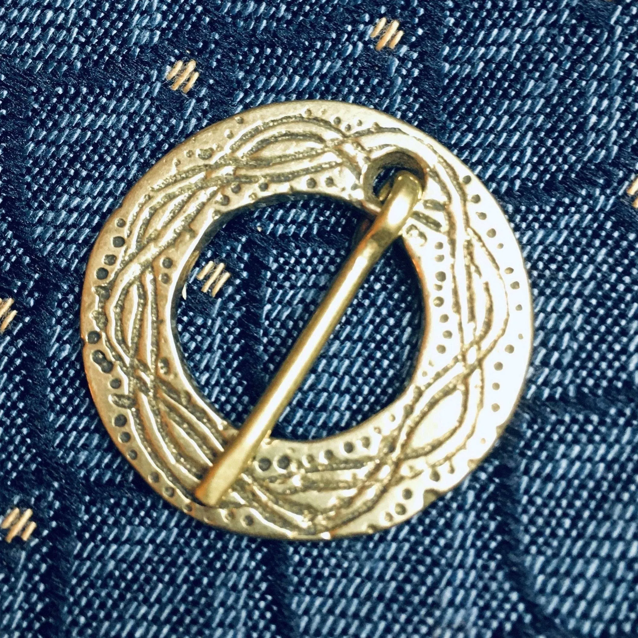 Round Medieval brooch with incised decoration
