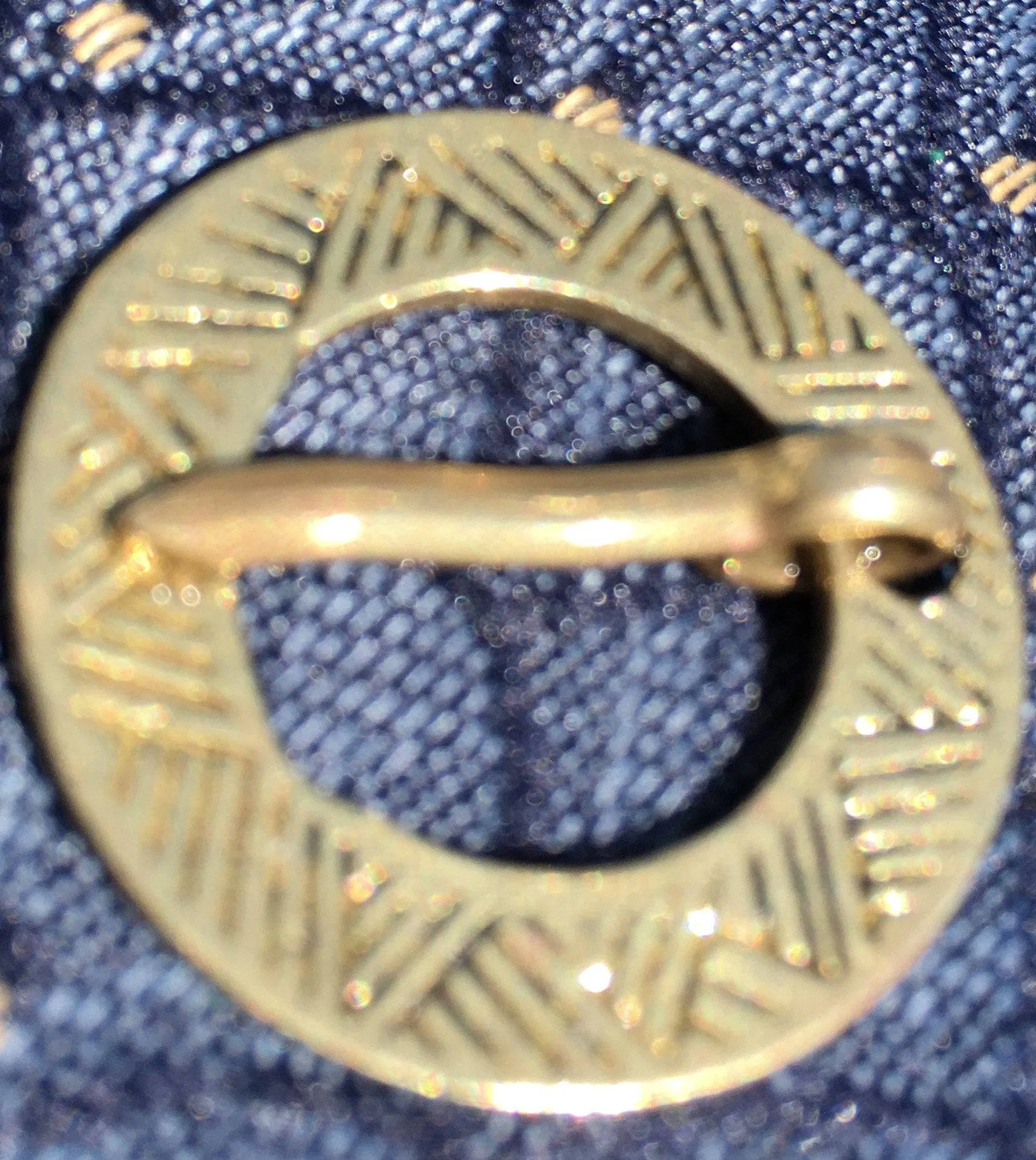Round Medieval brooch with incised decoration