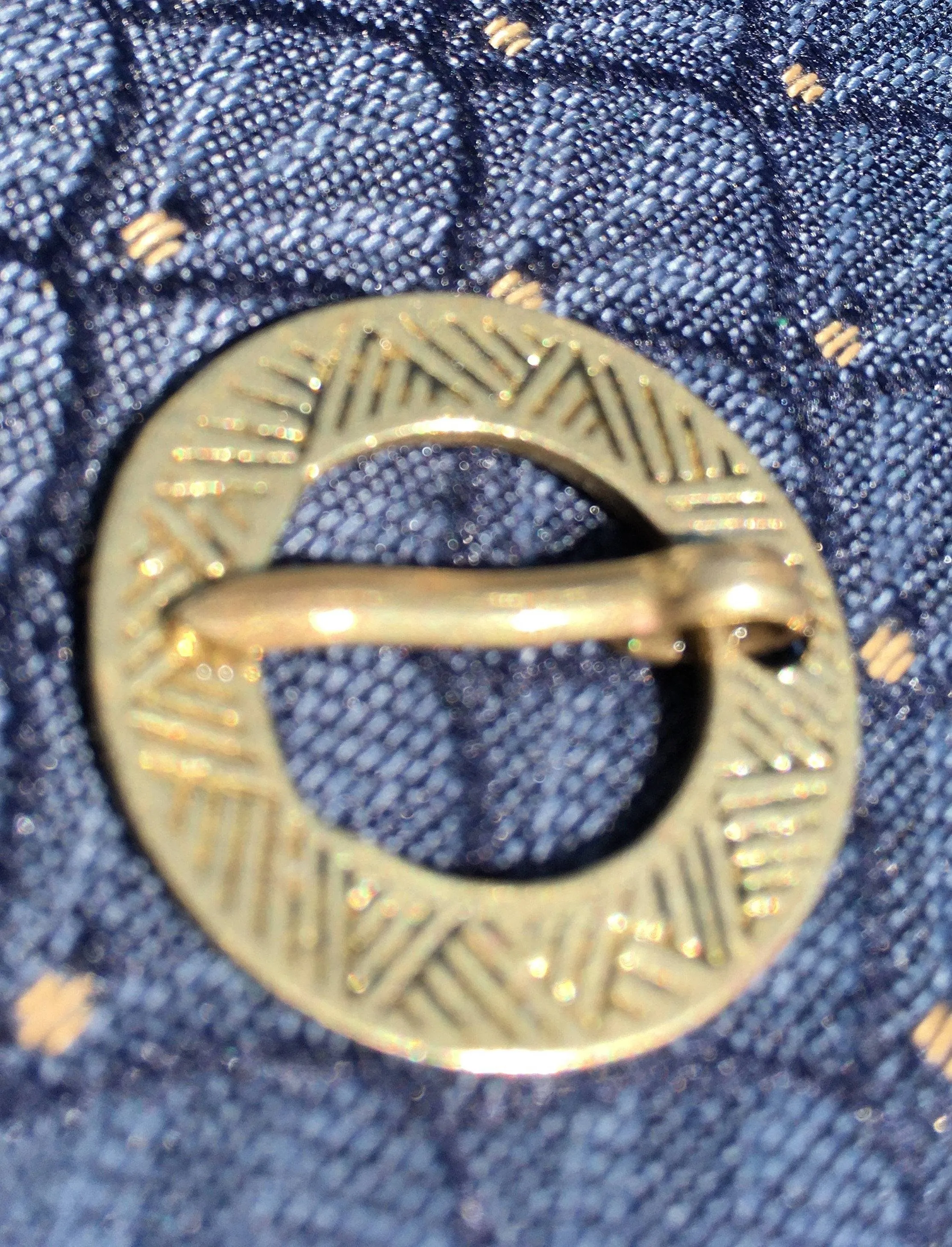 Round Medieval brooch with incised decoration